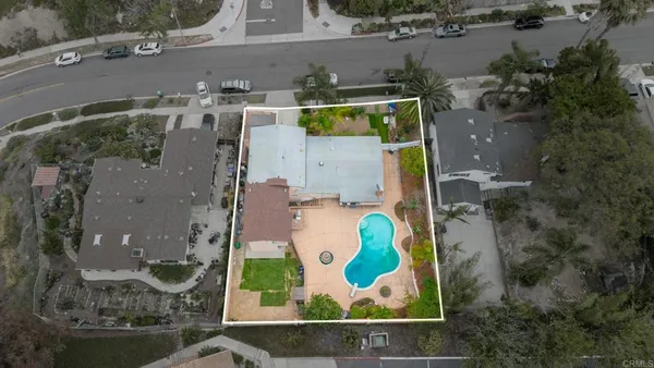 an aerial view of a house with a swimming pool and outdoor space