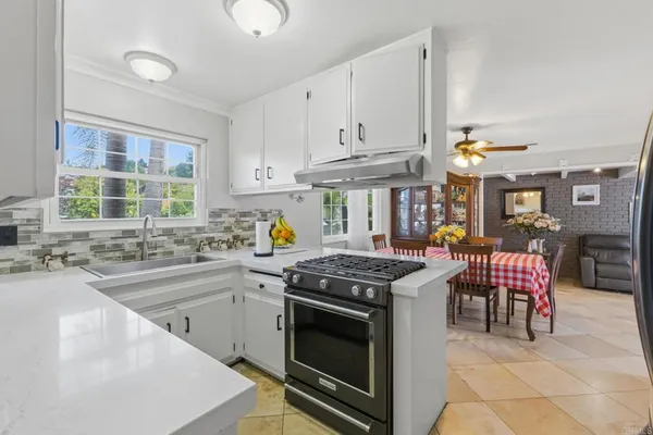 a kitchen that has a sink and a stove