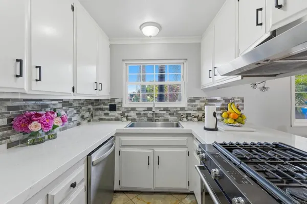 a kitchen with stove and cabinets
