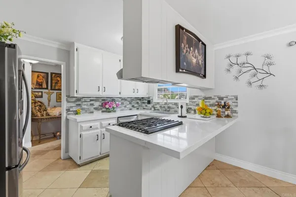 a kitchen with stainless steel appliances a stove microwave and cabinets
