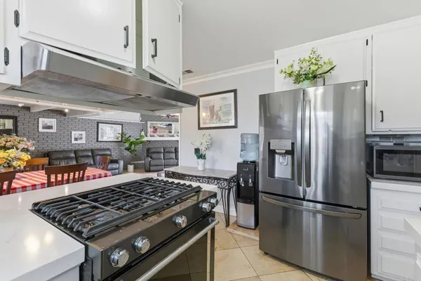 a kitchen with stainless steel appliances granite countertop a stove refrigerator and microwave