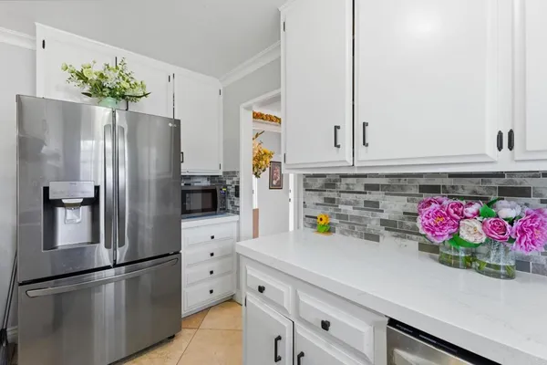 a kitchen with stainless steel appliances a refrigerator sink and cabinets