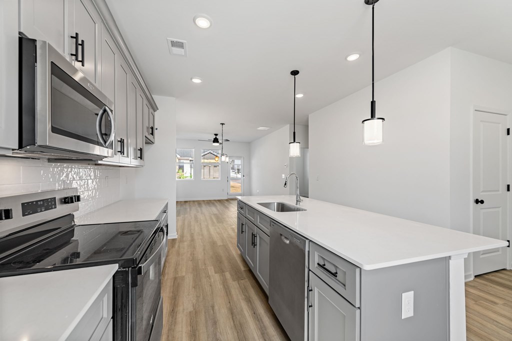 31 Grove Loop Blue Ridge, GA 30513 - Photo 15 of 47 a kitchen with stainless steel appliances granite countertop a sink a stove and a wooden floors