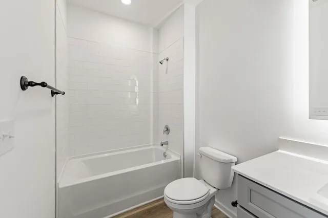 a white toilet sitting next to a bath tub