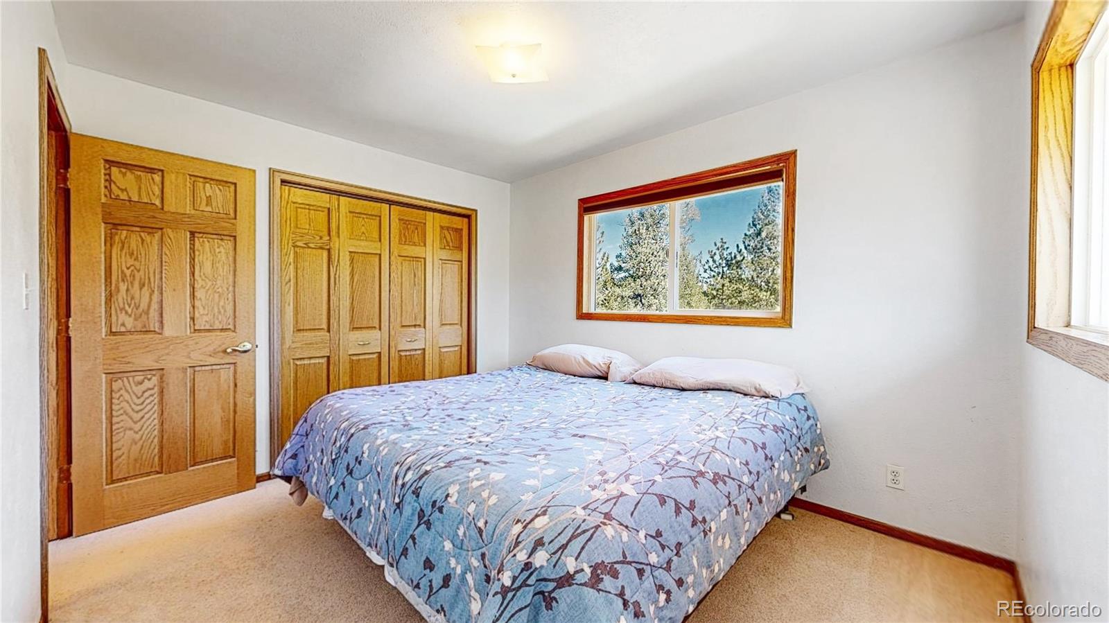 92 Four Bits Street Bailey, CO 80421 - Photo 16 of 50 a bedroom with a bed and a window