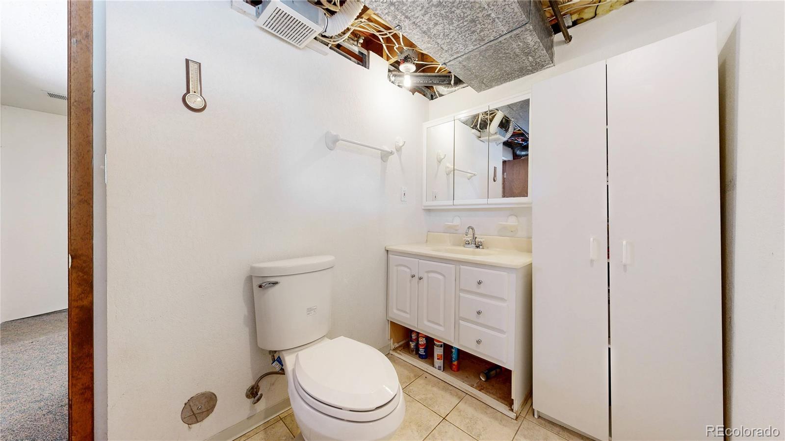 92 Four Bits Street Bailey, CO 80421 - Photo 24 of 50 a bathroom with a granite countertop toilet sink and mirror