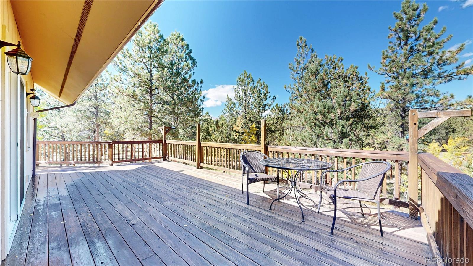 92 Four Bits Street Bailey, CO 80421 - Photo 30 of 50 a view of a chairs and table on the wooden deck
