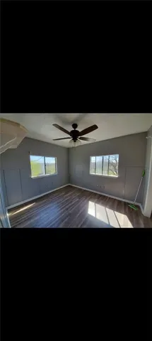 a view of an empty room with kitchen
