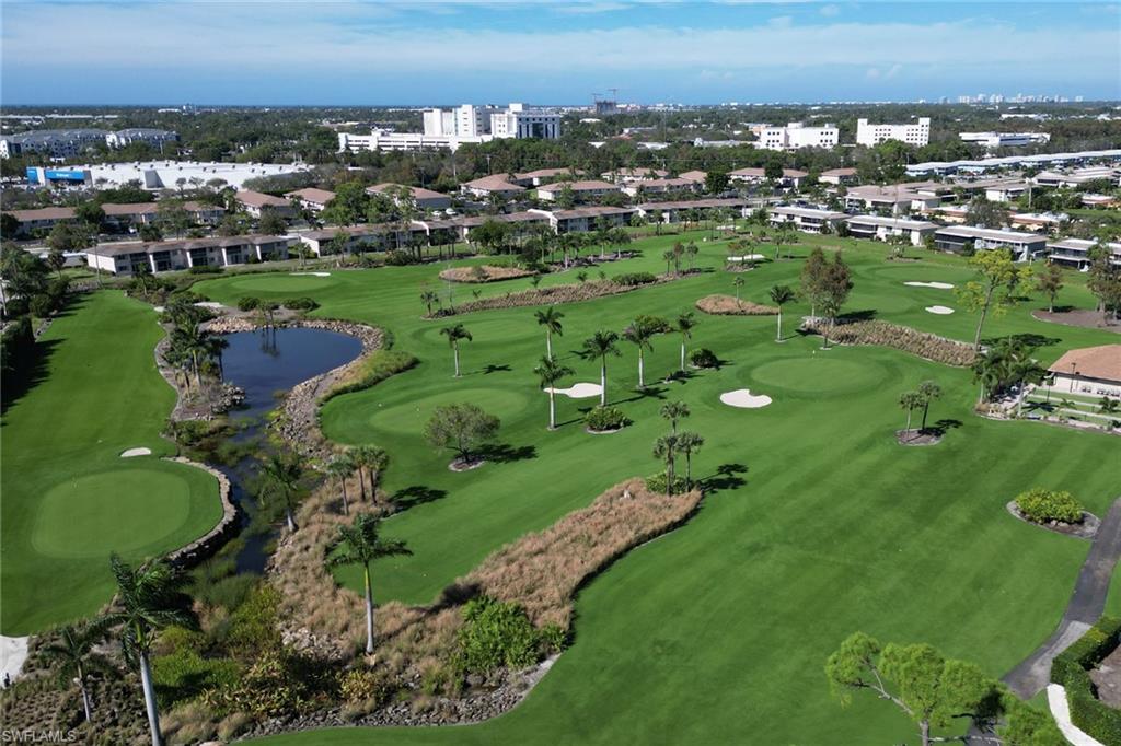 186 Harrison Road, Unit H4 Naples, FL 34112 - Photo 15 of 34 Aerial view of property and surrounding area featuring the Palmetto Course and a nearby body of water