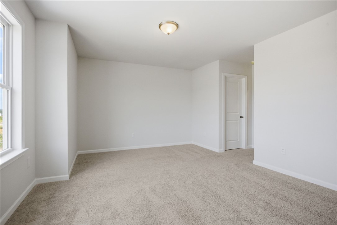 557 Hydrangea Street, Unit LOT 46 Seneca, SC 29678 - Photo 25 of 37 A spacious room offers comfortable carpet flooring and natural light from a large window.