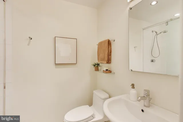 a bathroom with a toilet sink and shower