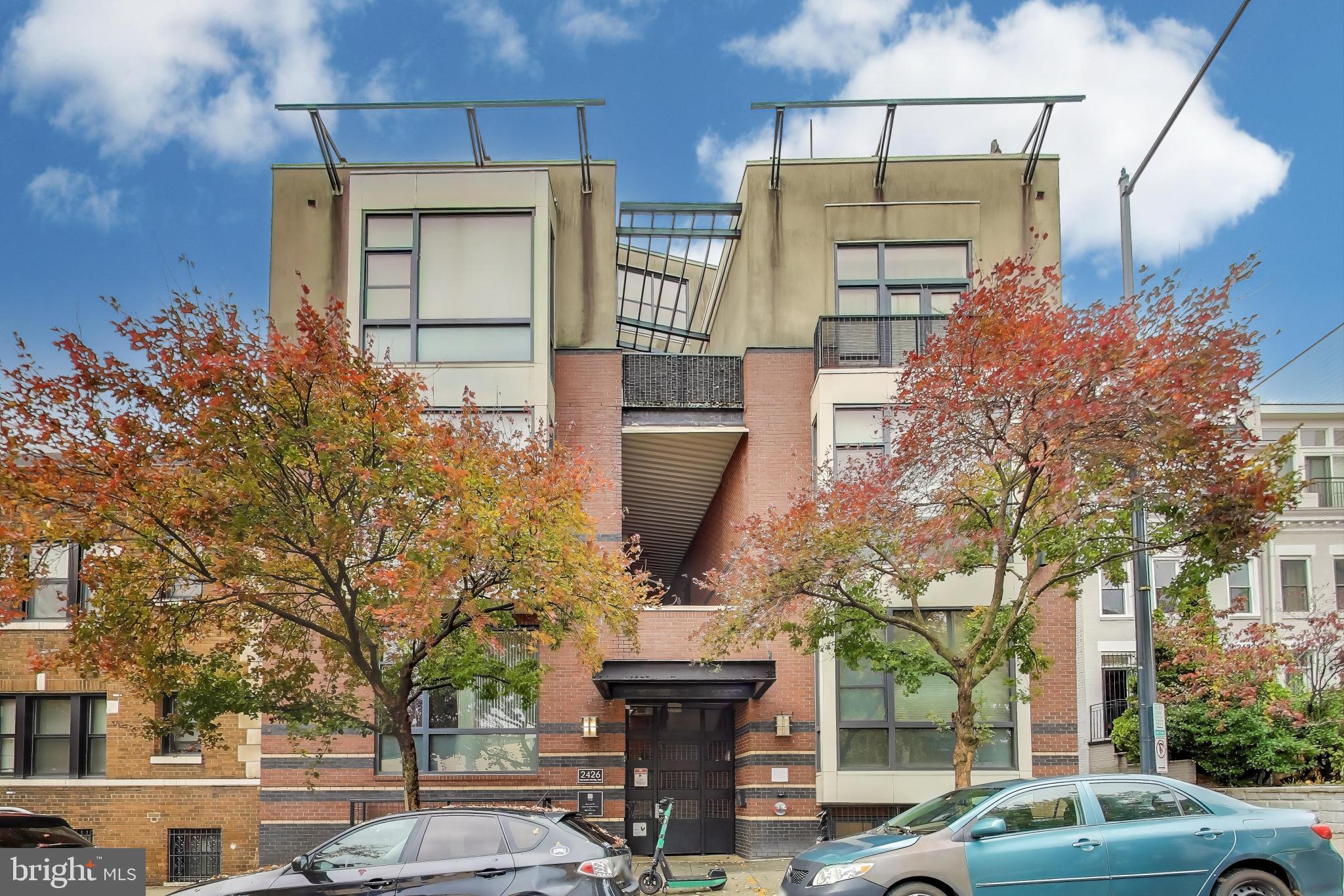 2426 Ontario Road Northwest, Unit 101 Washington, DC 20009 - Photo 21 of 22 a front view of a building with large tree