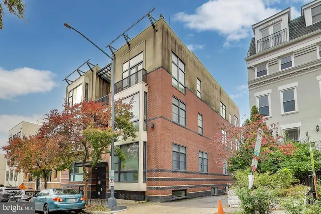 a city street lined with buildings and cars