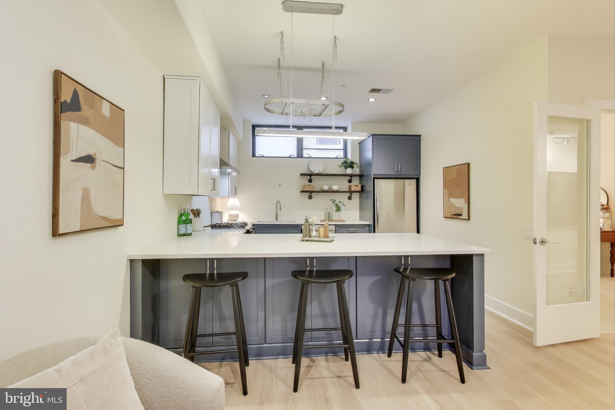 2426 Ontario Road Northwest, Unit 101 Washington, DC 20009 - Photo 5 of 22 a kitchen with cabinets table and chairs
