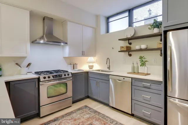 a kitchen with stainless steel appliances granite countertop a stove and a refrigerator