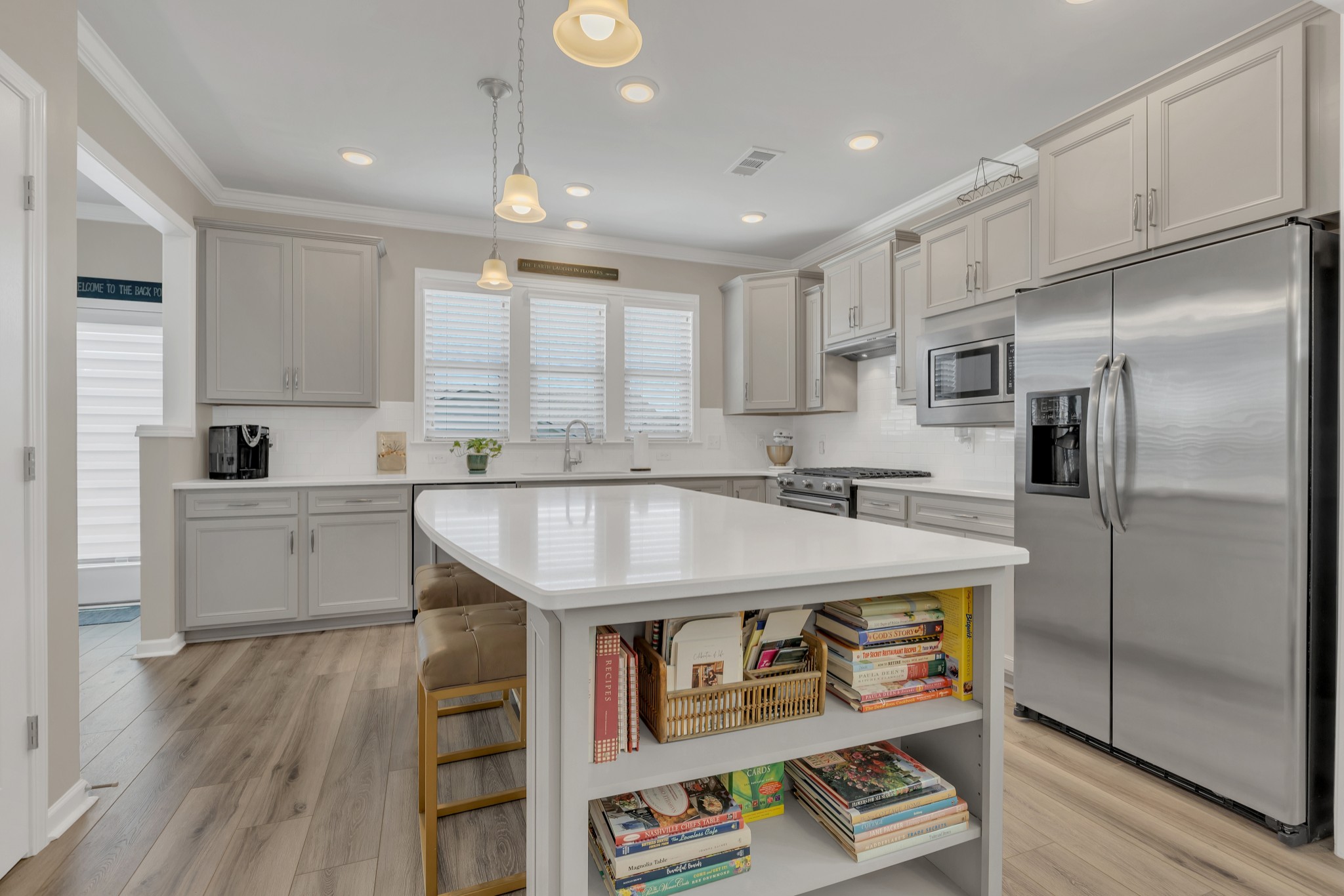 1224 Del Webb Boulevard Spring Hill, TN 37174 - Photo 14 of 47 a kitchen with stainless steel appliances granite countertop a sink a refrigerator and a stove with wooden floor