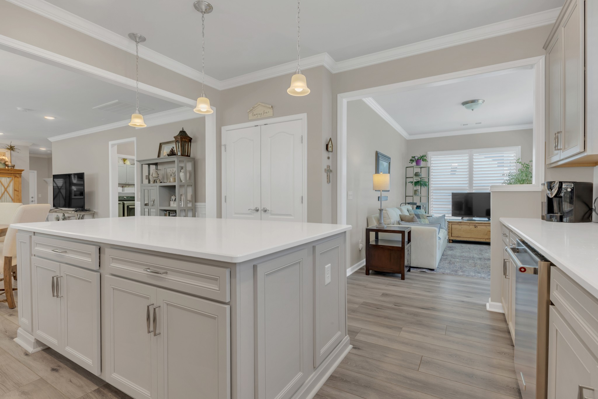 1224 Del Webb Boulevard Spring Hill, TN 37174 - Photo 16 of 47 a kitchen with kitchen island a sink and white cabinets