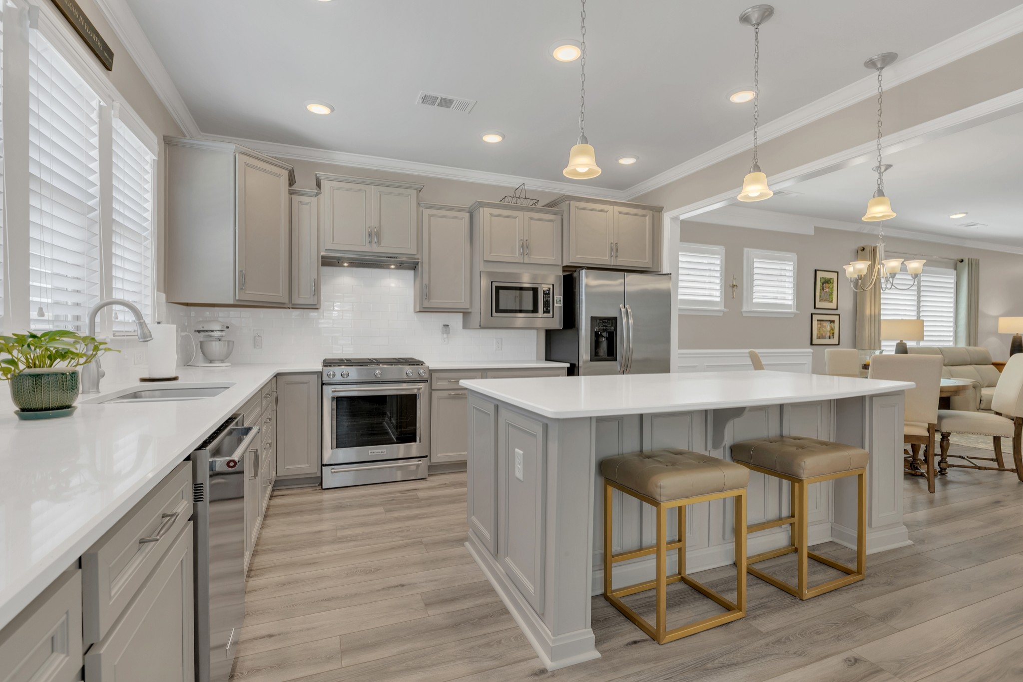 1224 Del Webb Boulevard Spring Hill, TN 37174 - Photo 17 of 47 a kitchen with kitchen island granite countertop a table chairs sink and cabinets