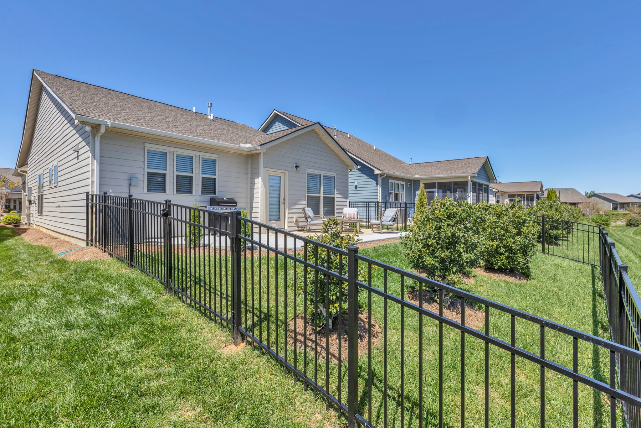 1224 Del Webb Boulevard Spring Hill, TN 37174 - Photo 30 of 47 a view of a house with wooden fence next to a yard
