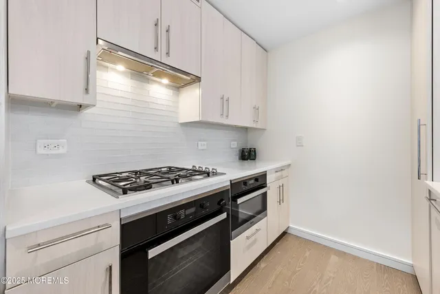 a kitchen with a stove and a microwave