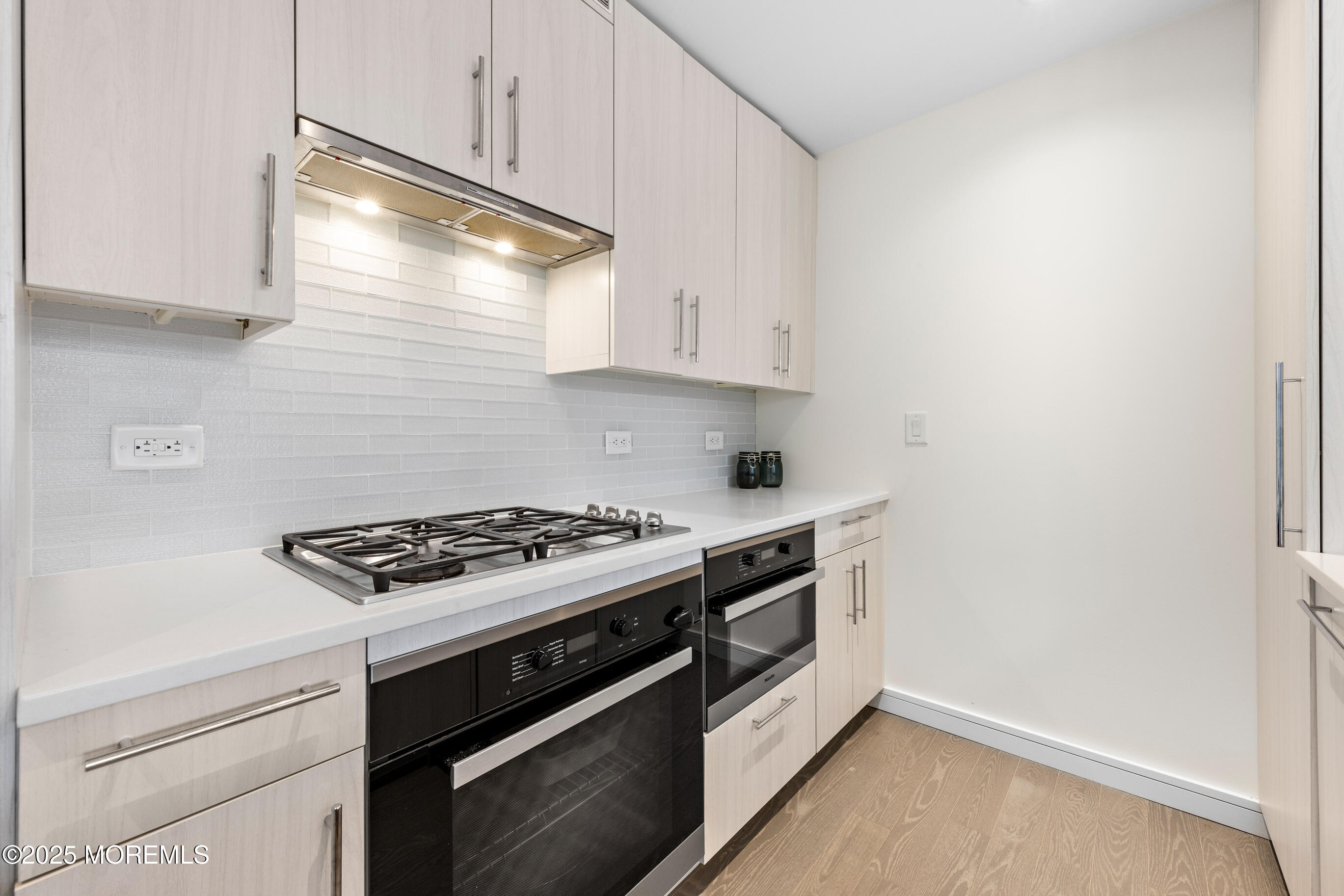 20 Melrose Terrace, Unit 511 Long Branch, NJ 07740 - Photo 11 of 35 a kitchen with a stove and a microwave