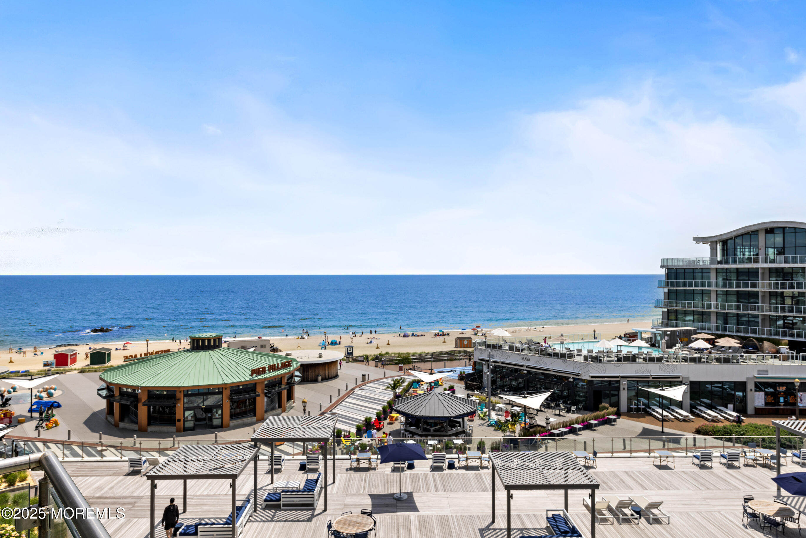 20 Melrose Terrace, Unit 511 Long Branch, NJ 07740 - Photo 2 of 35 a view of a swimming pool with a table and chairs under an umbrella
