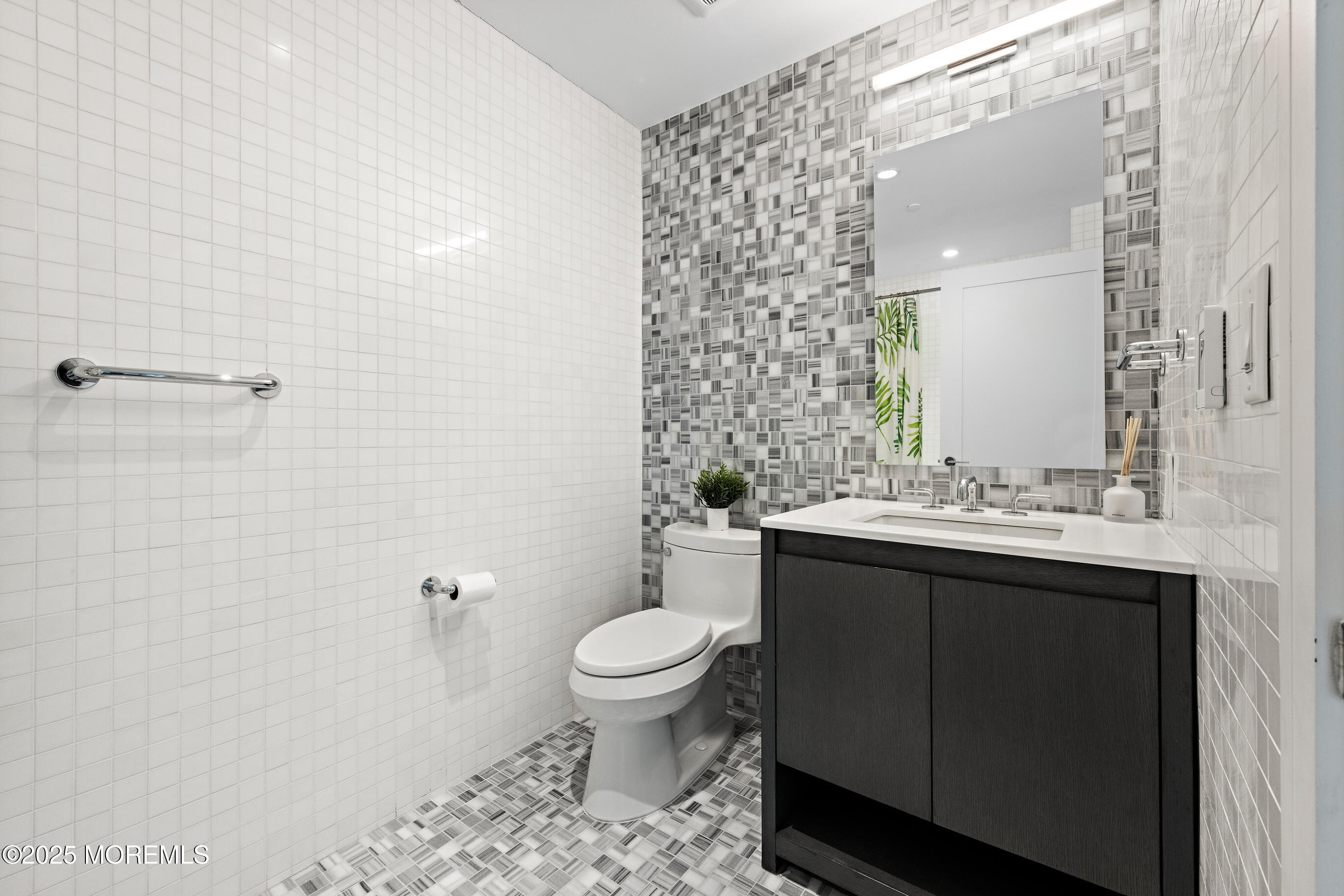 20 Melrose Terrace, Unit 511 Long Branch, NJ 07740 - Photo 22 of 35 a bathroom with a sink a toilet and shower