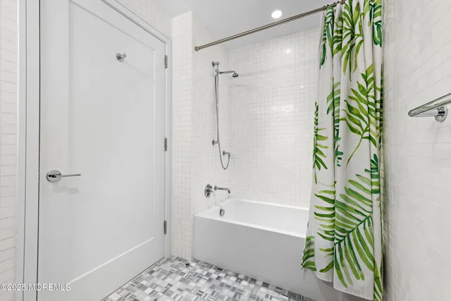 a bathroom with a bathtub and a shower