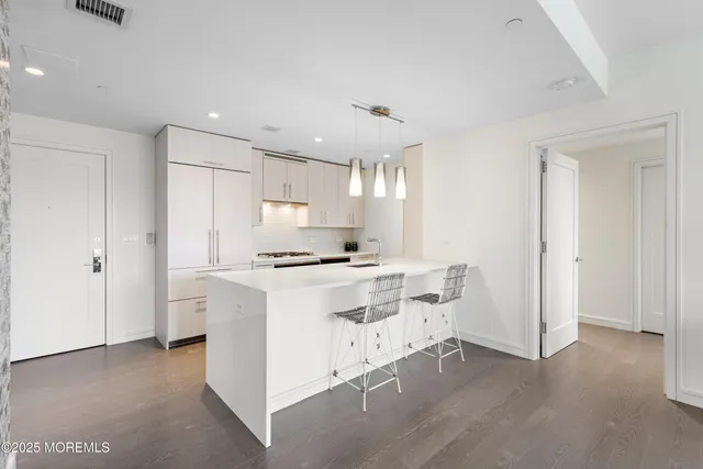 a kitchen with a stove a refrigerator and a sink