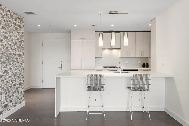 a view of kitchen with stainless steel appliances cabinets