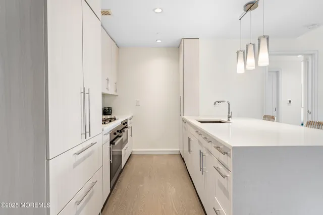 a kitchen with white cabinets and white appliances