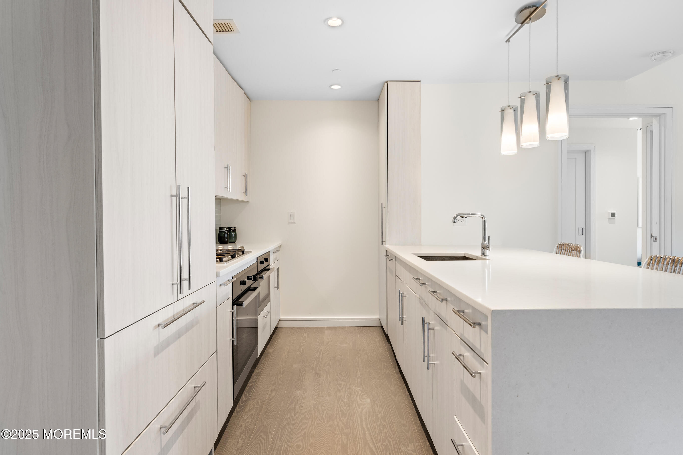 20 Melrose Terrace, Unit 511 Long Branch, NJ 07740 - Photo 10 of 35 a kitchen with white cabinets and white appliances