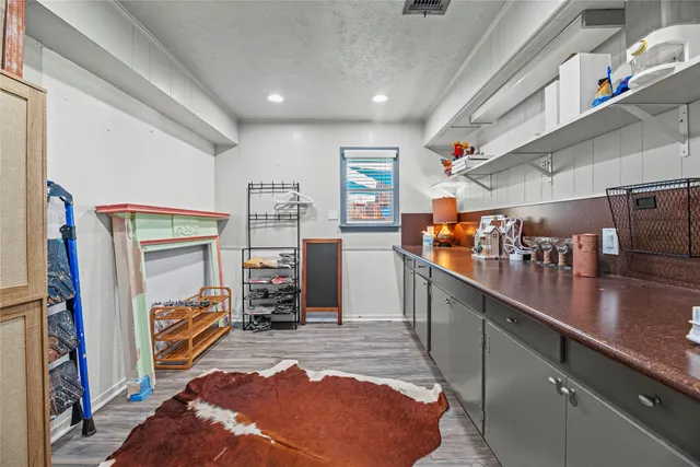 a room with lots of wooden furniture and a window