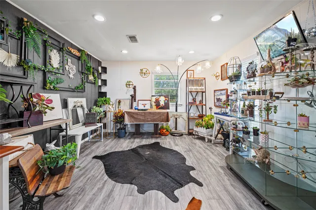 a living room filled with lots of furniture and a chandelier