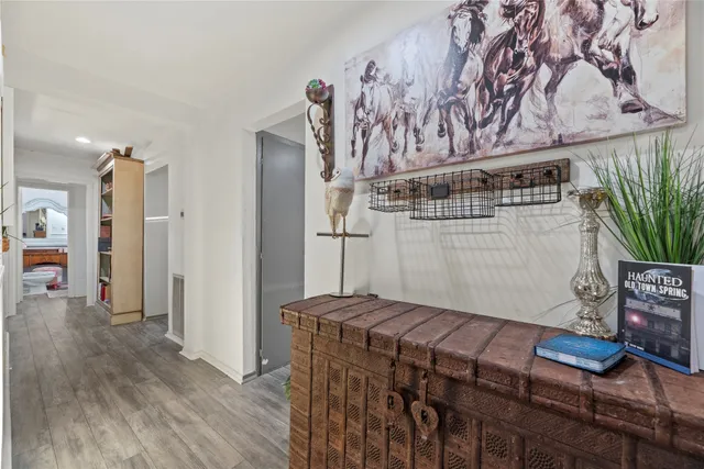 a view of a hallway with wooden floor and staircase