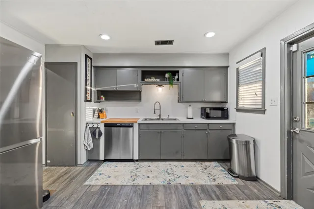 a kitchen with stainless steel appliances a refrigerator sink and stove