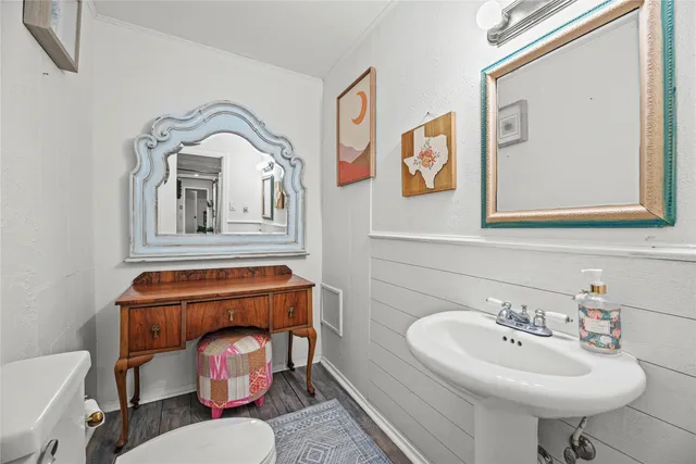 a bathroom with a toilet a sink and mirror