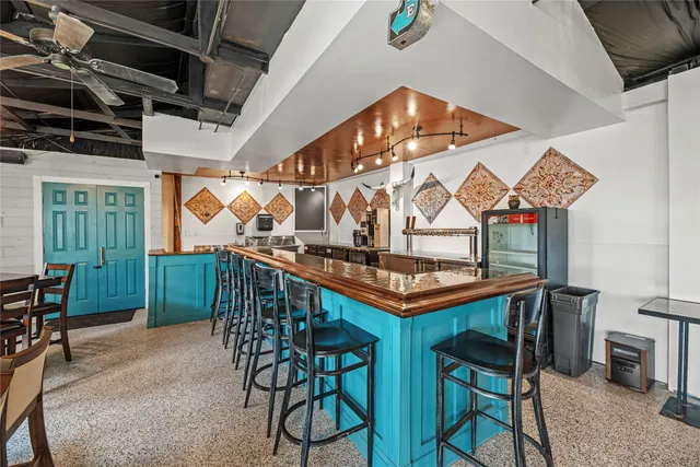 a dining room with a wooden table and chairs