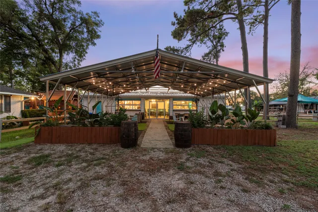 a view of a patio with table and chairs under an umbrella