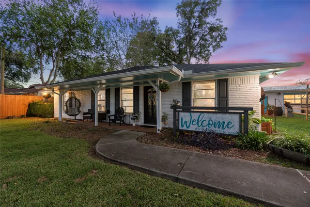 a front view of a house with patio and garden