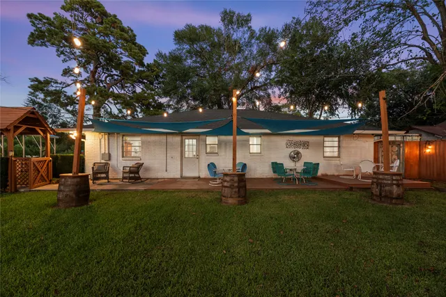 a front view of house with yard and outdoor seating