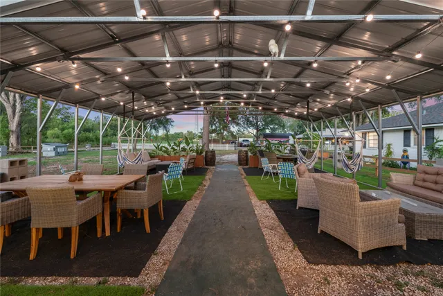 a view of a patio with table and chairs