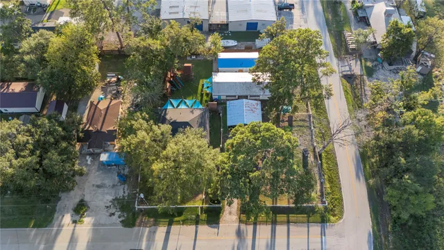aerial view of a house with large trees