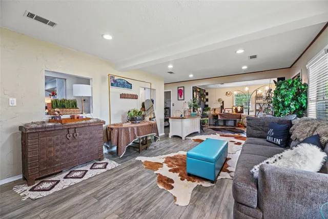a living room with furniture and a wooden floor