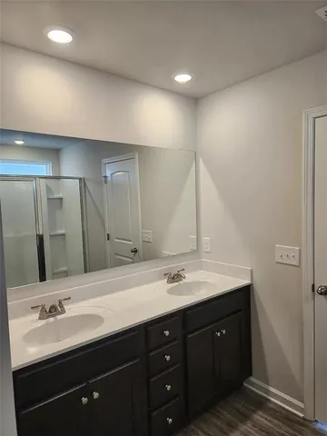 a bathroom with a double vanity sink and a mirror
