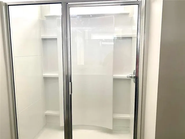 a bathroom with a glass shower door