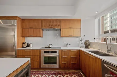 a kitchen with a sink stove and cabinets