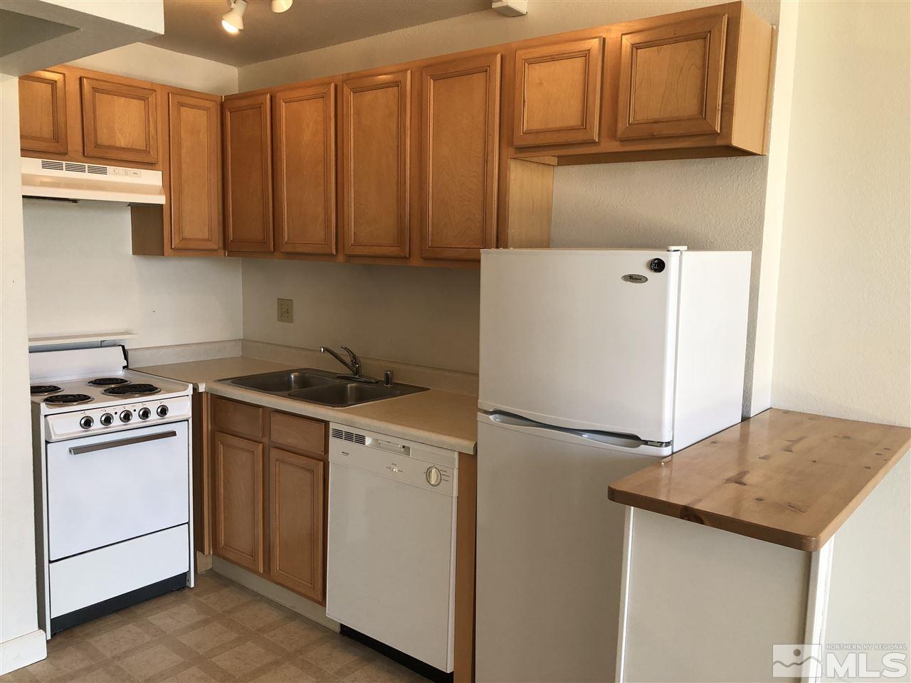 567 West 4th Street, Unit 601 Reno, NV 89503 - Photo 3 of 9 a kitchen with stainless steel appliances granite countertop cabinets and a refrigerator
