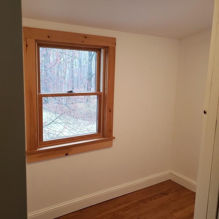102 Mason Road Dudley, MA 01571 - Photo 18 of 29 an empty room with wooden floor and a window