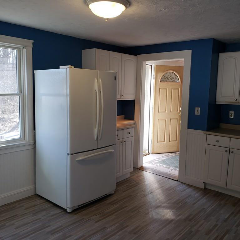 102 Mason Road Dudley, MA 01571 - Photo 5 of 29 a kitchen with stainless steel appliances a refrigerator and wooden floor